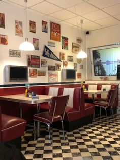 a restaurant with checkered floor and red booths