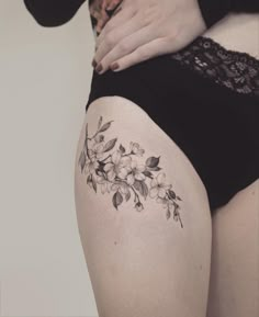 a woman's thigh with flowers on it