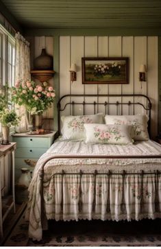 a bed sitting in a bedroom next to a window with flowers on top of it