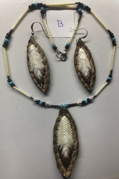 three pieces of jewelry are displayed on a white surface with a blue bead necklace and earring