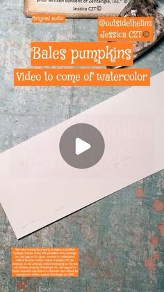 an image of a video to come out of watercolor paper on the table with scissors