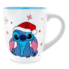 a coffee mug with a cartoon character wearing a santa hat