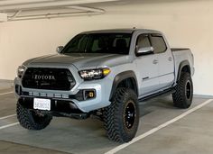 a silver toyota truck parked in a parking garage