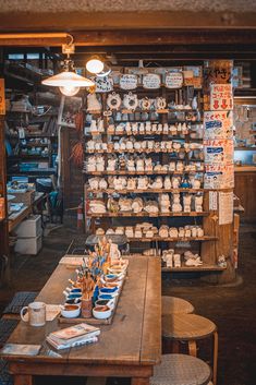 there are many cups and bowls on the table in this shop, all stacked together