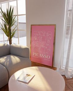 a living room with a couch, coffee table and potted plant