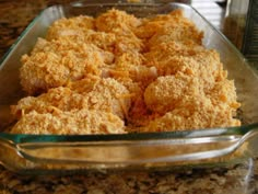 a glass casserole dish filled with food on top of a table