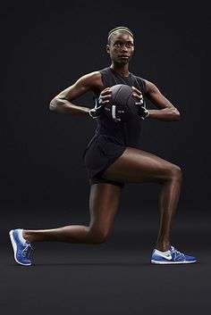 a woman is running with a ball in her hand and shoes on the other side