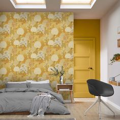 a bedroom with yellow wallpaper and grey bedding