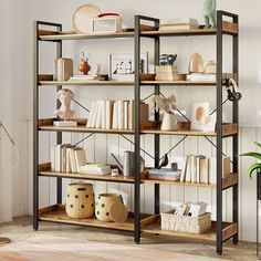 a bookshelf filled with lots of books next to a plant in a living room