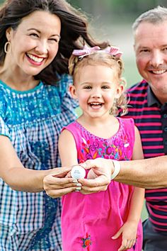 a man, woman and child are holding something in their hands