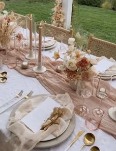 the table is set with plates, silverware and napkins for an elegant dinner