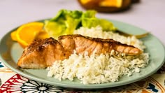 salmon and rice on a plate with orange slices