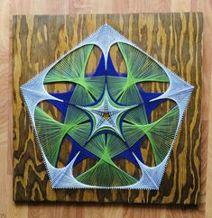 an intricately designed artwork is displayed on a wooden surface