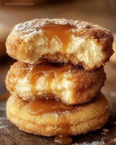 two doughnuts stacked on top of each other with caramel sauce drizzled over them