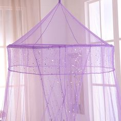 a purple mosquito net hanging from the ceiling