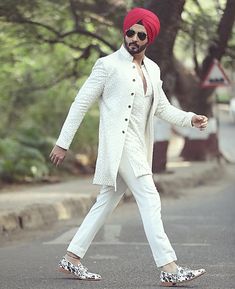 a man in a turban crossing the street with his foot on one side