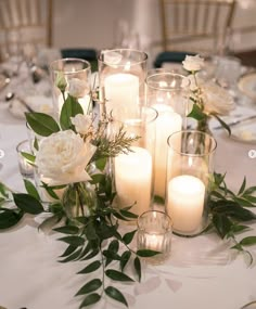 the table is set with candles and plates