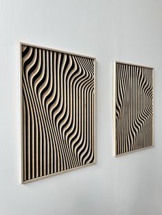 two black and white paintings on a wall