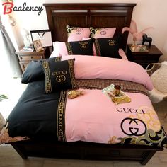 a bed with black and pink comforters on it