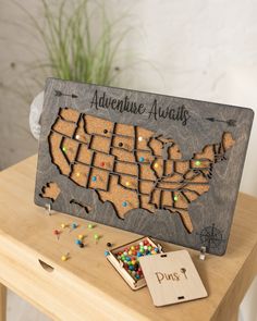 a wooden sign with the map of the united states on it and some candies in front of it