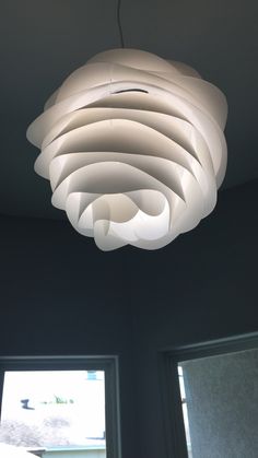 a white light hanging from the ceiling in a room