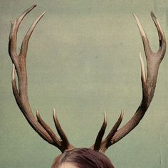 a woman with red hair and antlers on her head