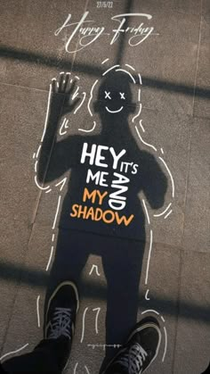 someone standing in front of a chalk drawing on the sidewalk that says hey it's me and my shadow