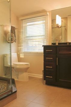 a bathroom with a sink, toilet and shower