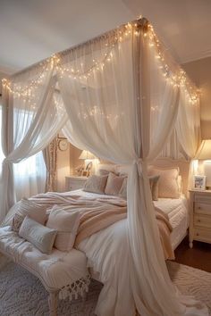 a bed with white curtains and lights on the headboard is in a room that has carpeted flooring