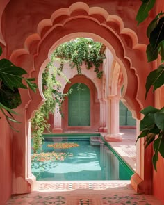 an outdoor swimming pool surrounded by greenery and pink walls with archways leading to it