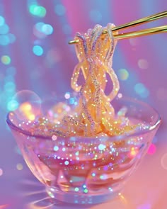 a bowl filled with noodles and chopsticks on top of a pink tablecloth