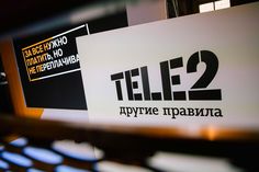 there is a sign that says tele2 in russian and two other languages on it