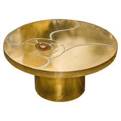 a brass table with an artistic design on it