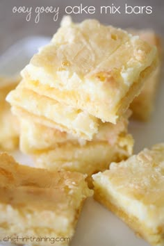 there is a pile of cake mix bars on the plate with text overlay that says boozy gooey cake mix bars