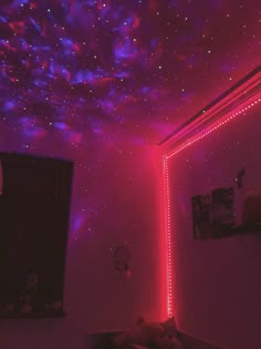 the ceiling is covered in stars and pink lights as well as some pictures on the wall