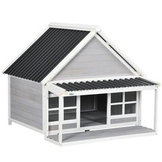 a dog house with a black roof and white trim on the top, is shown in front of a white background