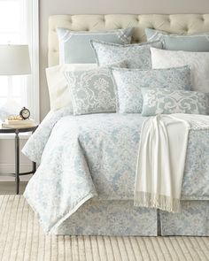 a bed with blue and white comforters in a bedroom