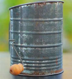 there is a metal barrel with a snail on the side and a stick sticking out of it