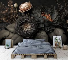 a bed sitting in front of a wall with flowers painted on it's side