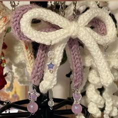 a close up of some kind of jewelry hanging on a rack with other items in the background