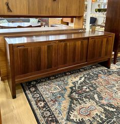 a large wooden cabinet sitting on top of a rug