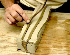 a person working on something that is being made out of plywood and some kind of wood