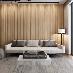 a modern living room with wood paneling on the wall and white couches in front