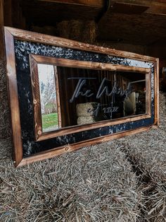 a barn with hay in it and a mirror on the wall