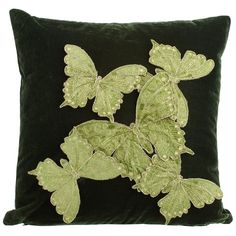 a green velvet pillow with embroidered butterflies on the front and back, sitting on a white background