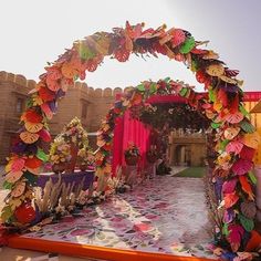 an outdoor ceremony setup with paper flowers