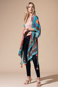 The bohemian wardrobe staple every woman needs! This stunning mixed floral print kimono features breezy side slits, half-length kimono sleeves, and a relaxed oversize fit. Throw it on at the beach for a quick cover-up or style it with your favorite jeans and a band tee for a cool everyday look. Mixed floral print Relaxed, oversize fit 1/2 length kimono sleeve Mid-length Side vents Open front Bohemian style One size fits most 100% Viscose Length: 38" Width: 40" Cover-up Bohemian Kimono With Boho Print For Beach Cover-up, Bohemian Printed Kimono For Beach Cover-up, Bohemian Multicolor Tassel Cover-up, Hippie Printed Kimono For Beach Cover-up, Multicolor Vacation Kaftan With Tassels, Multicolor Tasseled Kaftan For Vacation, Multicolor Tassel Kaftan For Vacation, Bohemian Multicolor Kimono As Beach Cover-up, Bohemian Multicolor Kimono For Beach Cover-up