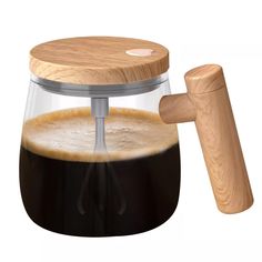 a coffee maker with a wooden handle and glass container on the top, is shown in front of a white background