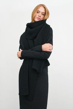 Knitted in our soft merino-blend toledo yarn, our Queens Scarf is a little sister to our ultra-oversized Bronx. Queens features the same cozy knit and texture at a scaled-down size—still more than generous enough to wrap yourself in for extra warmth.[SPLIT] Emmy, in black, is 5'10.5" (179 cm). Astrid, in olive, is 5'9" (175 cm) tall. Total length is approximately 82" (210 cm), or 6'10" long. Width is approximately 12" (31 cm). French Merino Wool Blend (20% Merino Wool, 80% Acrylic). Dry clean fo Black Oversized Scarf, Black Knit Scarf, Black Crochet Scarf, Chunky Knit Wool Scarf For Fall, Chunky Scarf Outfit, Olive Coat, Chunky Crochet Scarf, Bulky Scarf, Mohair Scarf