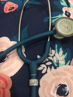 a stethoscope laying on top of a flowery blanket